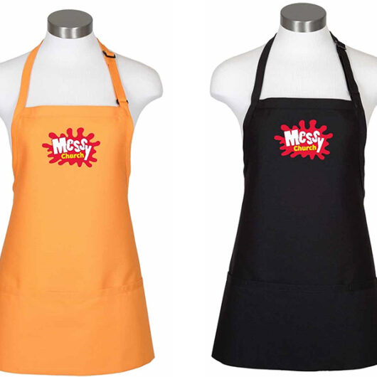 yellow and black aprons with the Messy Church logos on them
