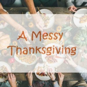 A Thanksgiving dinner table with lots of food and family